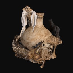 ceramic sculpture of a horse-headed snake-like animal wrapped around a vase