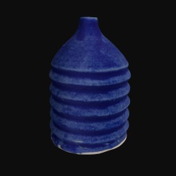 dark blue textured ceramic sculpture with coil detail and small round opening at the top