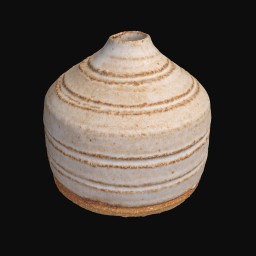 grainy textured ceramic sculpture with rounded bottom and circular detail with small round opening at the top
