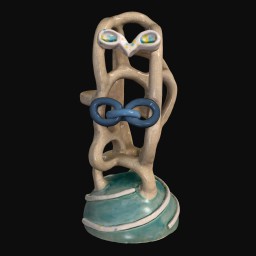 Face-like sculpture with blue base and white eyes