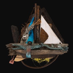 collage of industrial material including wood and rusted metal in the shape of a sailboat