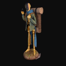 Golden figurine with backpack and a green jacket