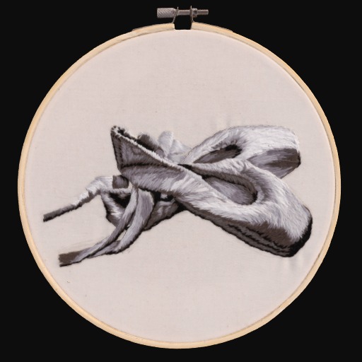 Embroidered ballet shoes on a cream fabric circle
