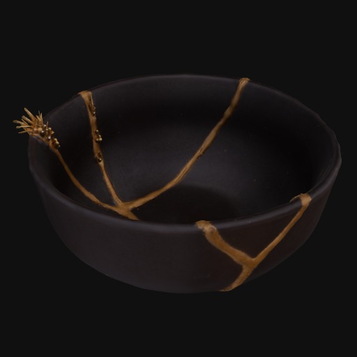 black ceramic bowl with gold vertical lines growing across the middle and outside.