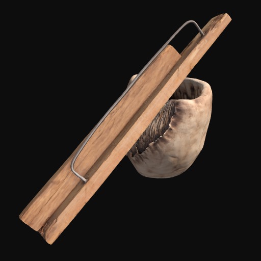 long piece of wood with metal handle lying diagonally across a rock