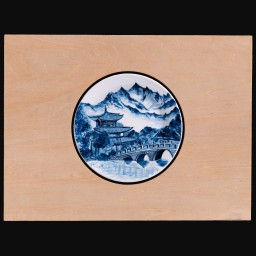 Circular Image of blue and white Chinese building in front of mountains