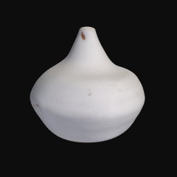 white ceramic sculpture with pointy top and rounded bottom