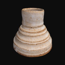 grainy ceramic sculpture with rounded top and coiled detail