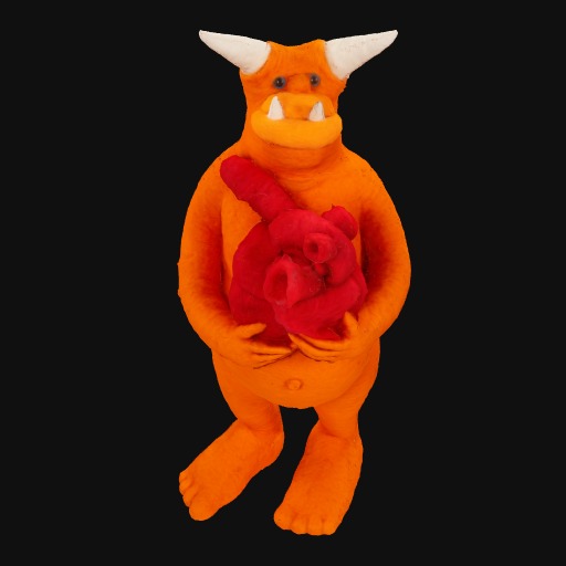 orange felt monster, white horns, holding red heart.