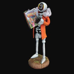 Robotic figurine holding comic book