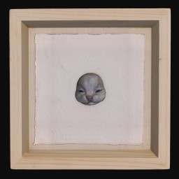 Blue ceramic cat face mounted in a wooden frame