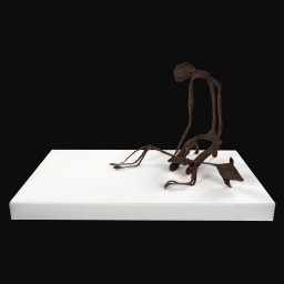Iron painted wire and papier-mâché sculpture on white plinth of a man, slumpted, holding a dog lying down