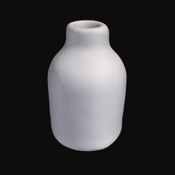 white ceramic sculpture with small rounded opening at the top