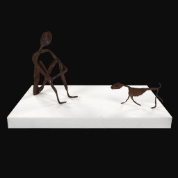 Iron painted wire and papier-mâché sculpture on white plinth of a dog approaching a man, sat down.