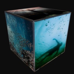 cube sculpture with images of silhouette floating in ocean underwater