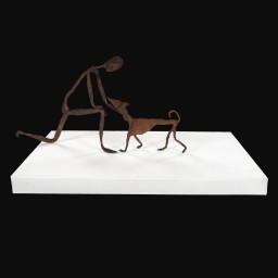 Iron painted wire and papier-mâché sculpture on white plinth of a man greeting a dog with his hand.