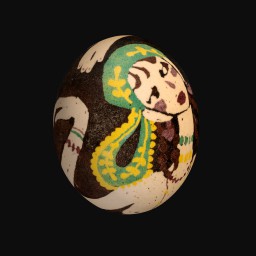 painted egg depicting a woman with a green and yellow head scalf